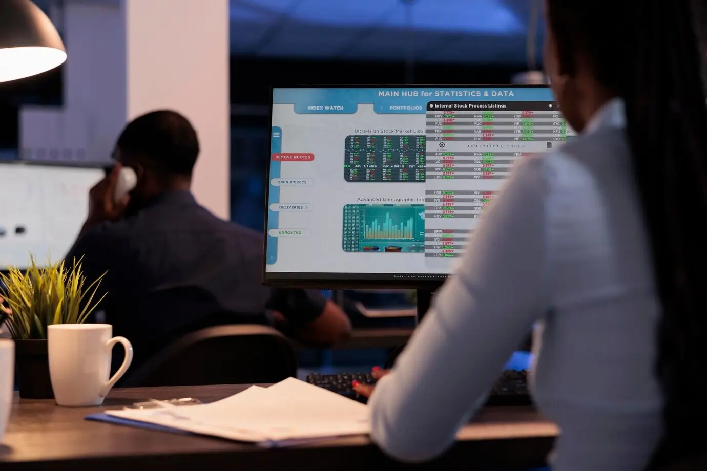 Женщина-брокер наблюдает в реальном времени за продажами на фондовом рынке, анализируя статистику мировой биржевой торговли для инвестирования капитала. Ночью при торговле на Форекс работает с прибылью индекса хедж-фонда.